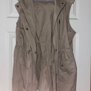 Vest with pockets, hood, and draw string